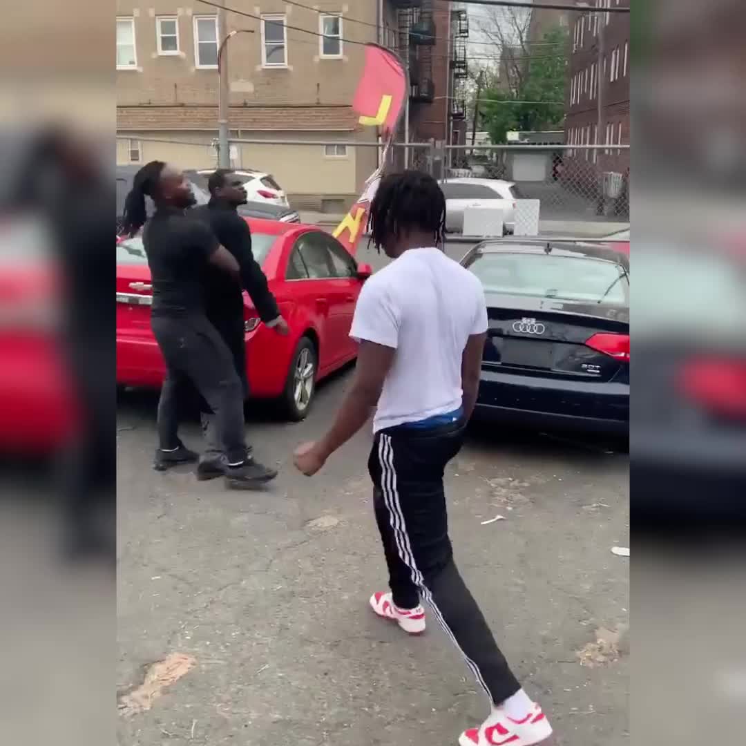 Men fight at a car lot