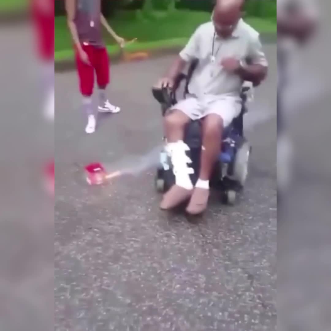 Terry tries to light a firework in a wheelchair